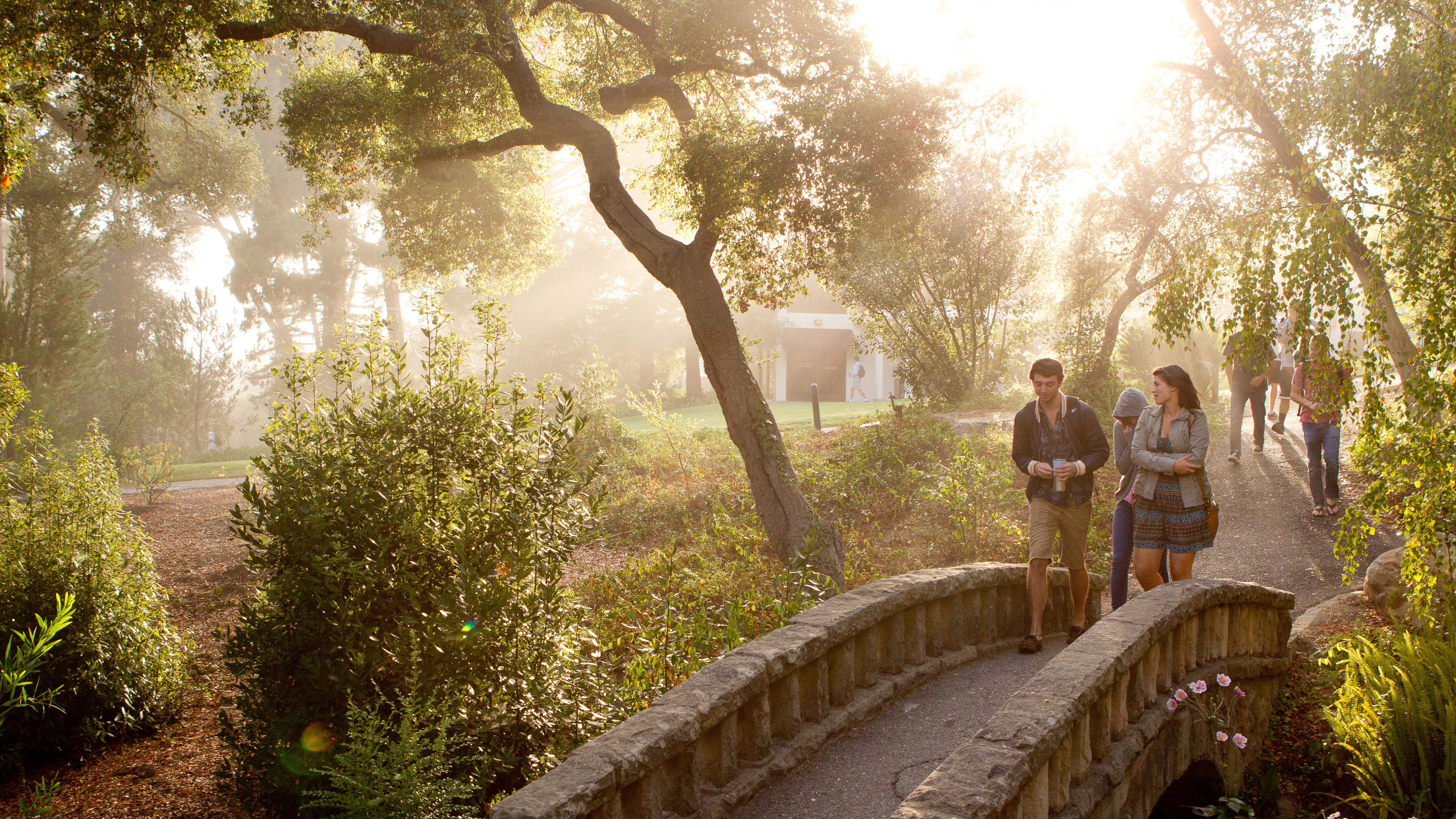 students walking on campus bridge